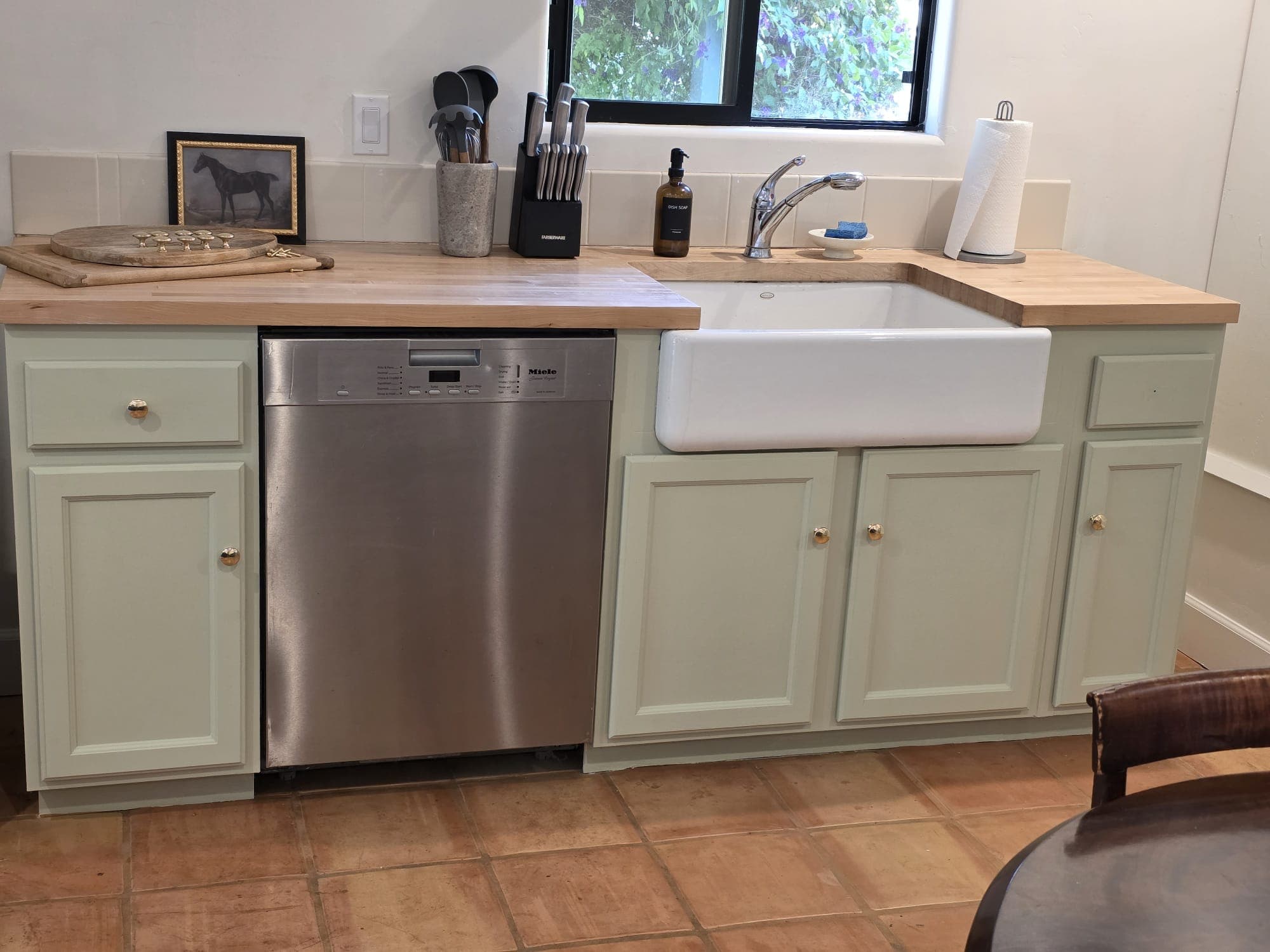 Kitchen cabinets after refinishing in a soft green color