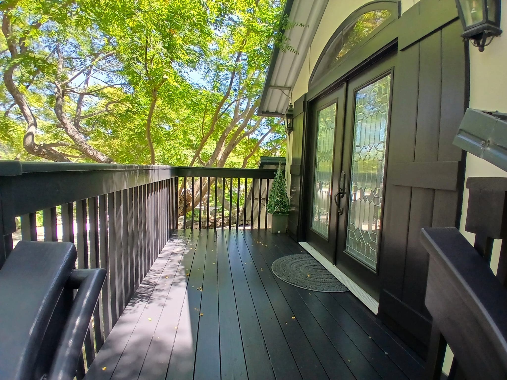 Finished deck entry with dark painted boards and railings