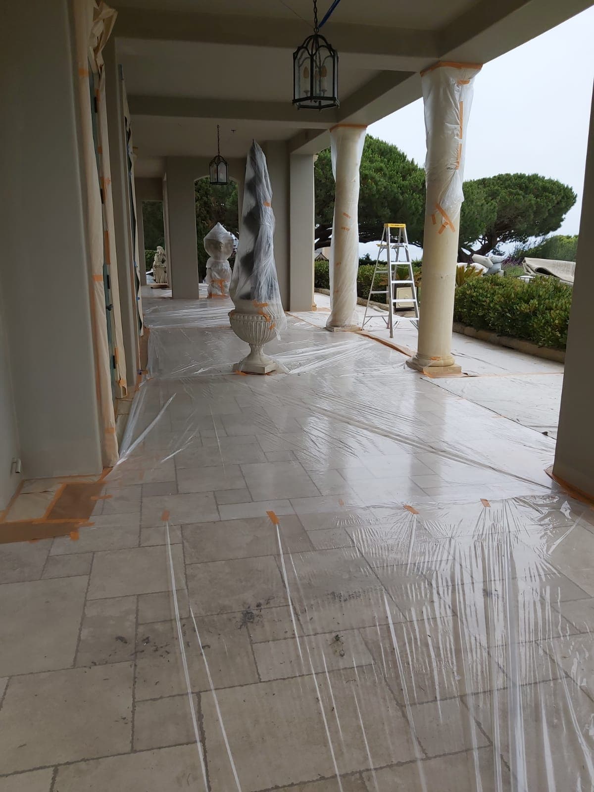 Interior painting project with floors and walls carefully protected before painting